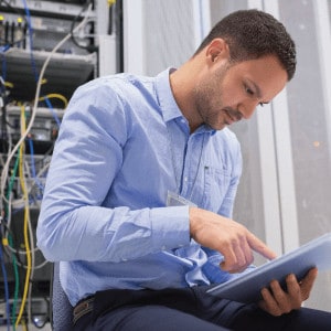 Man With Tablet Near Server Rack