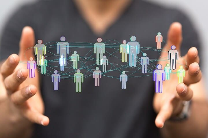 people figures connected through waved lines floating in-between a persons hands