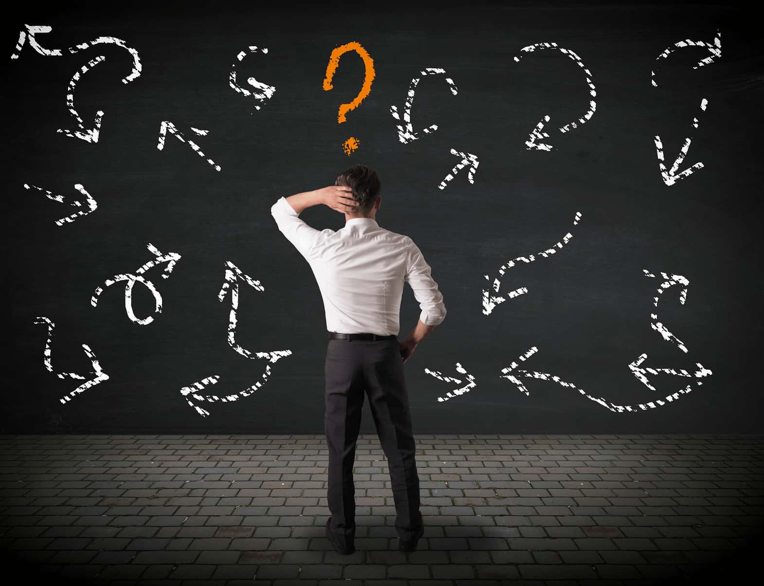 a professional individual standing with his hand on his head looking confused at a wall with arrows pointing in different directions
