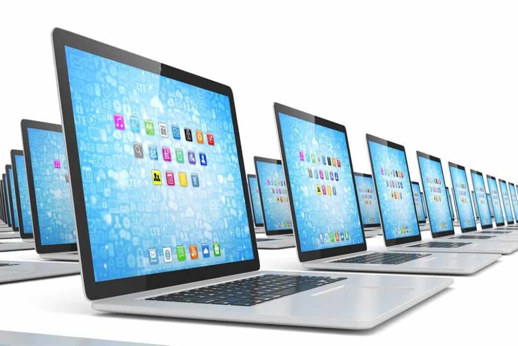 Open laptops on white background with blue screen display