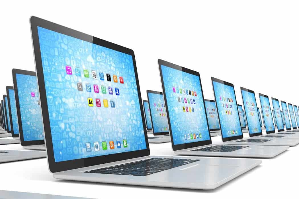Open laptops on white background with blue screen display