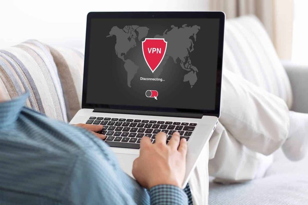 Man holding laptop disconnecting VPN