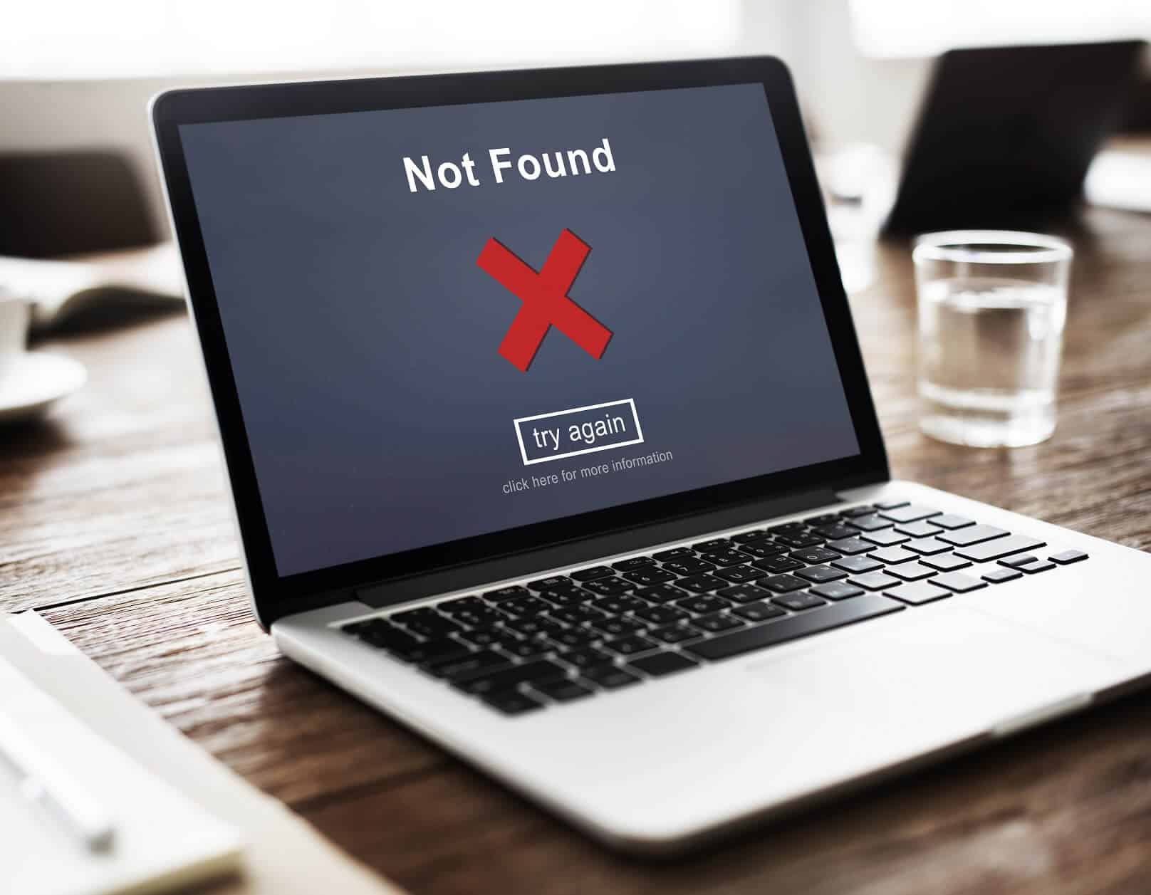Laptop with black screen showing page not found alert