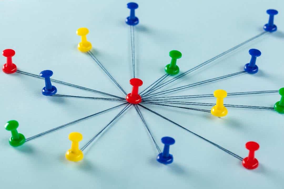 Red, green, yellow, and blue pins pins connected by strings