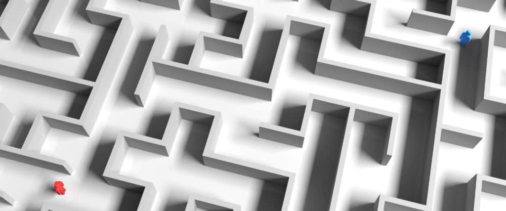 overhead shot of a maze with a blue person on one end and a red person on the other.