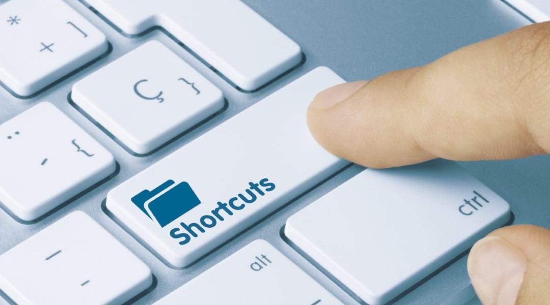 close up of a person pressing the shift button that has been replaces by shortcuts on a keyboard.