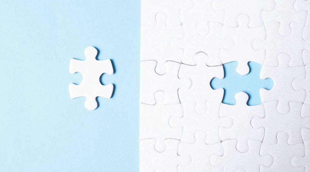 white puzzle piece next to a white puzzle missing a puzzle piece