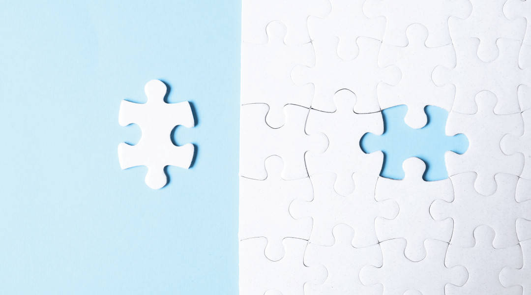 white puzzle piece next to a white puzzle missing a puzzle piece
