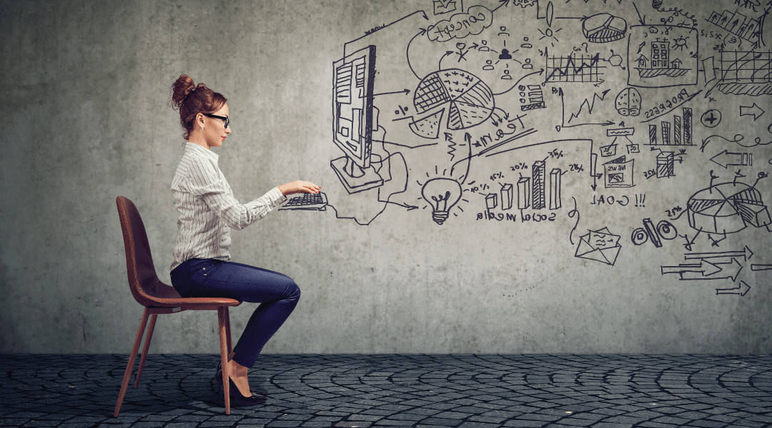 an individual sitting on a chair to make it look like she is working on the computer that is draw on the concrete wall behind her.