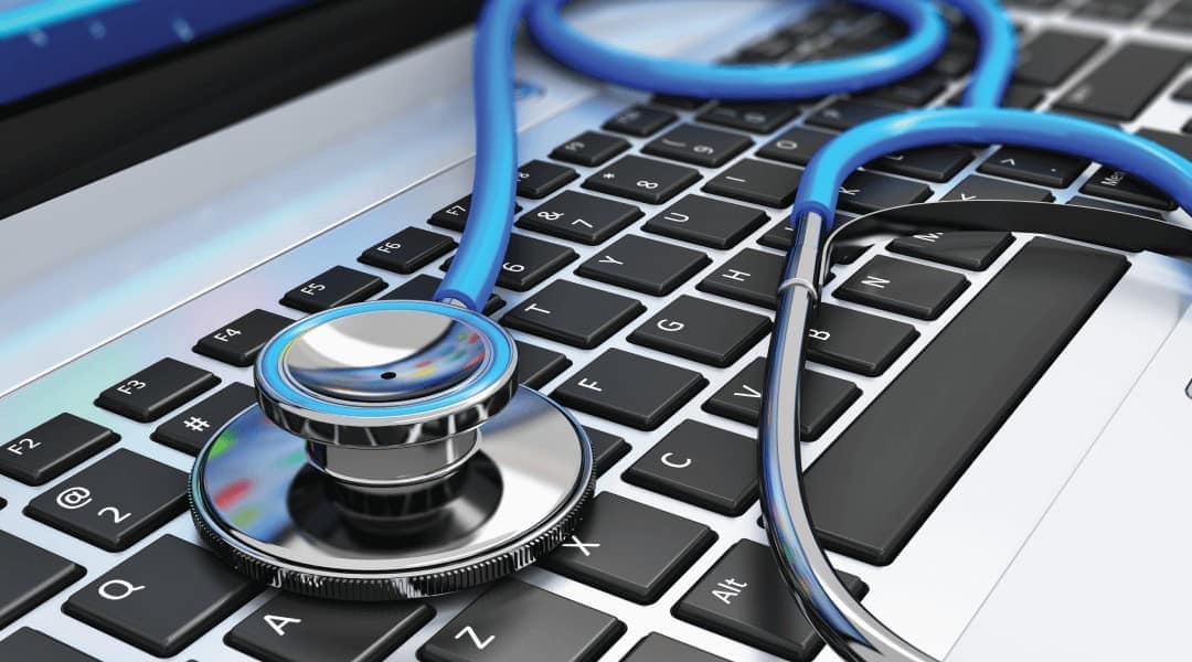 a close up of a blue and silver stethoscope on a laptop keyboard.