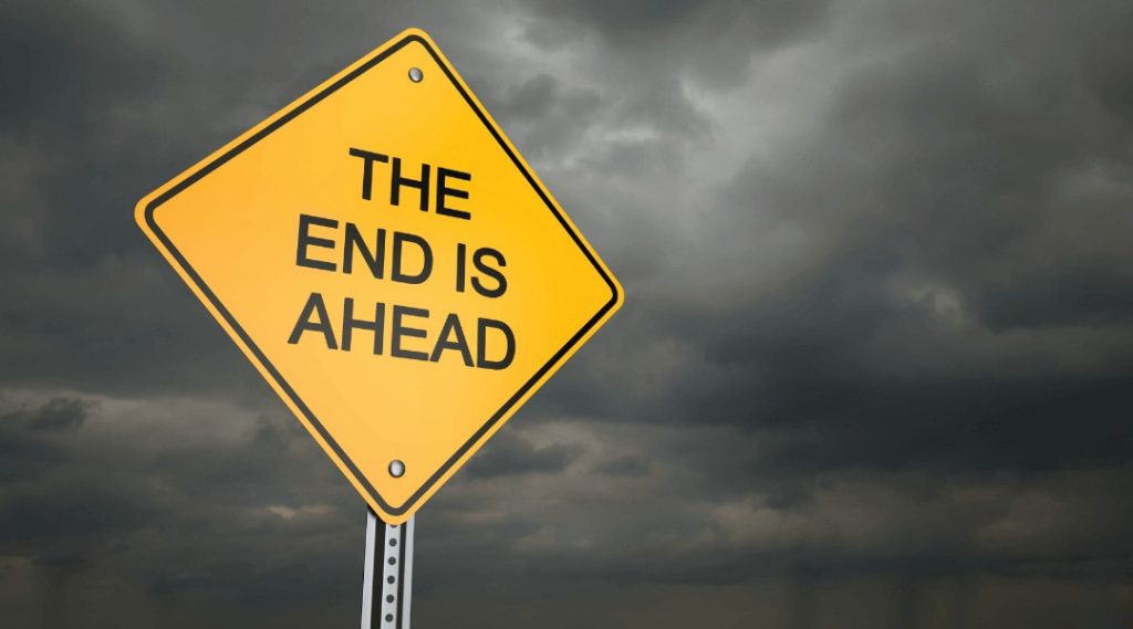 Yellow road sign "The end is ahead"