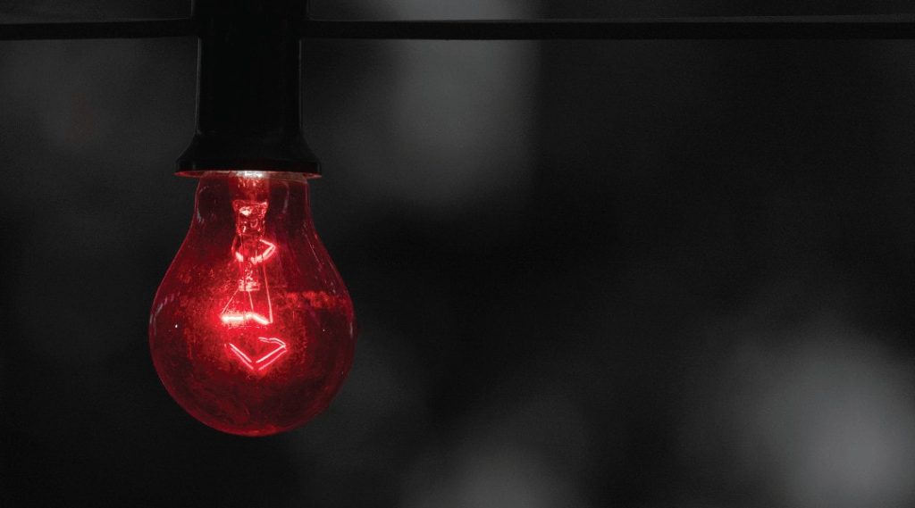close up of a light bulb that is tinted red