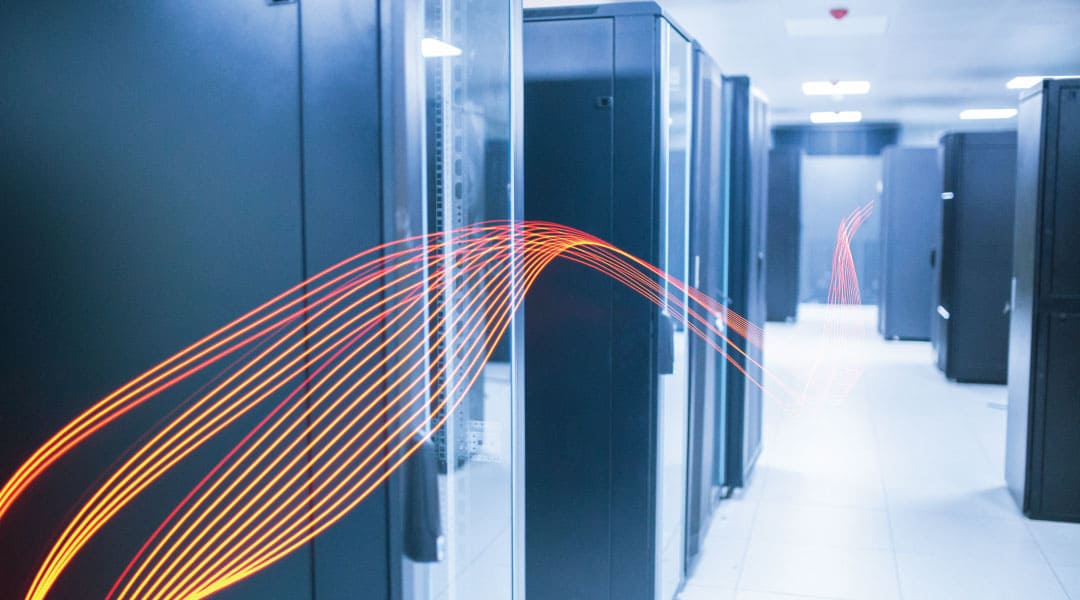 an orange high tech stream weaving through a room of industrial storage servers