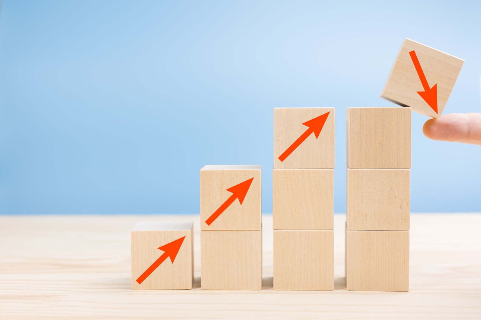 wooden blocks moving up in ascending order and the block at the top falling down