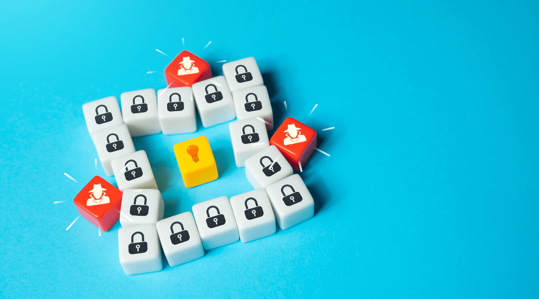 Concept image showing small white blocks with lock icons surrounding a yellow key with a lightbulb, and red keys with hacker icons, representing data breach threats and layered cybersecurity defenses.