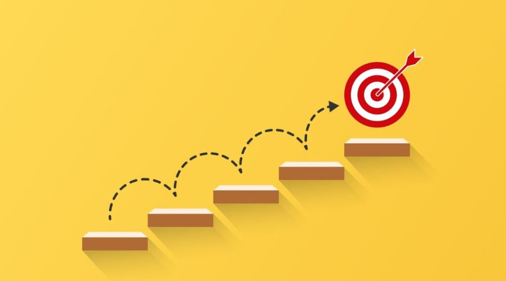 Steps leading to a bullseye target, representing business growth and goals achieved